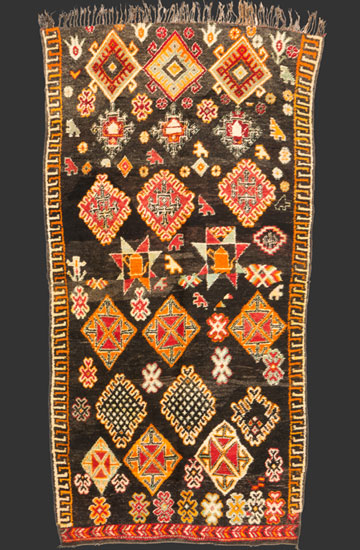 TM 2298, Ait Seghrouchène pile rug with rare black ground, northern central Middle Atlas, Morocco, 1970s/80s, 340 x 180 cm (11' 2'' x 6'), slightly fragmentary condition (it has been cut in half in the middle due to a heritage + re-assembled later), high resolution image + price on request







